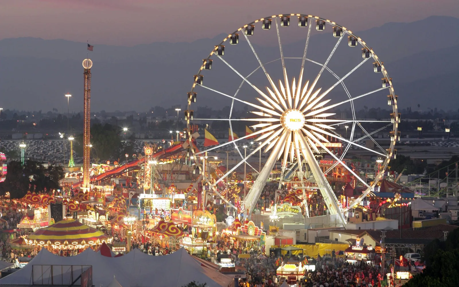 Ferris wheel and carnival rides at Fairplex at dusk